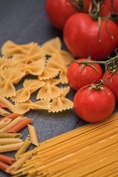 food background on rustic wood with pasta and tomatoes