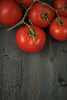 Fresh tomatoes on vintage wooden table