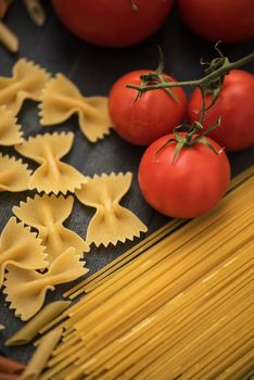 food background on rustic wood with pasta and tomatoes