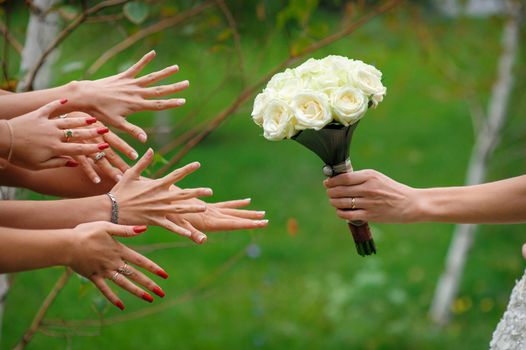 bride stretches a beautiful wedding bouquet