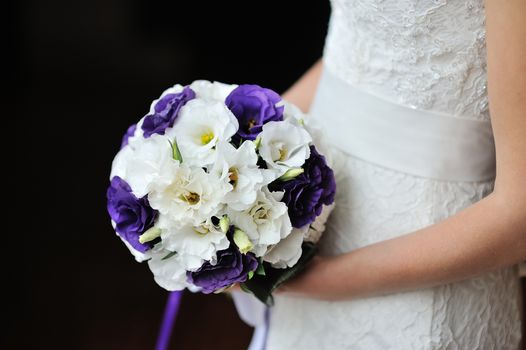 Beautiful wedding bouquet in hands of the bride