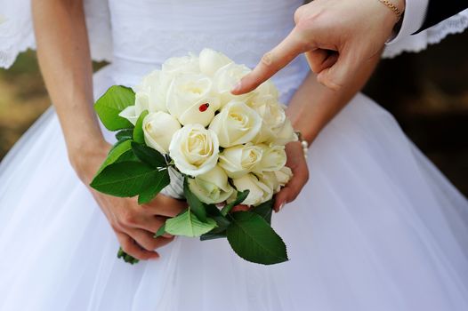 Beautiful wedding bouquet in hands of the bride