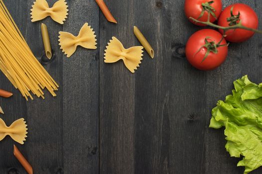 food background on rustic wood with pasta and tomatoes