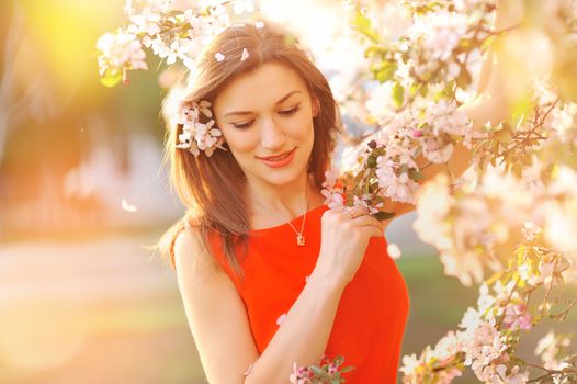 beautiful young girl on a background of flowering trees