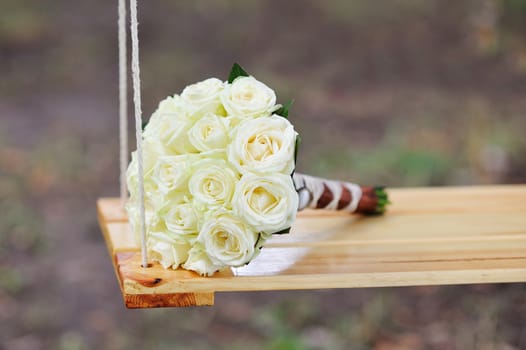 bridal bouquet lying on the swing