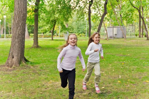 Photo of two running girls in summer