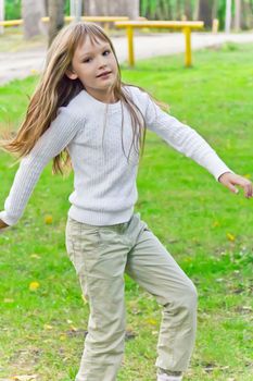 Photo of cute playing girl in summer