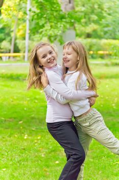 Photo of two playing girls in summer