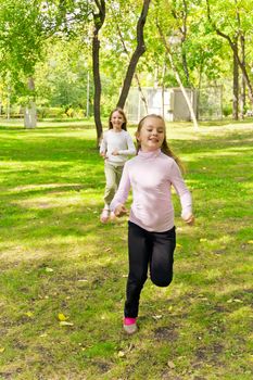 Photo of two running girls in summer