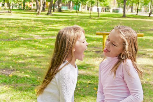 Photo of two playing girls in summer