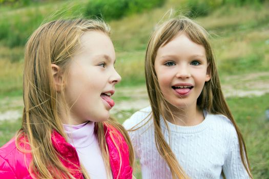 Photo of two playing girls in summer