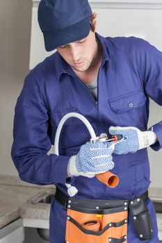 The plumber fixing a pipe