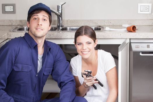 Couple plumbers looking at camera