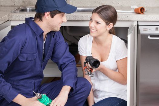 Pair of plumbers with plumbing parts
