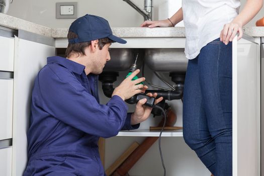 Plumber fixing a sink