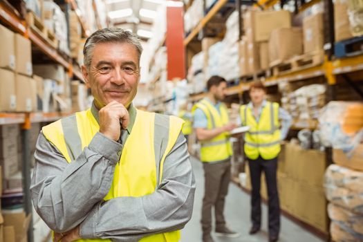 Portrait of smiling warehouse manager in a large warehouse