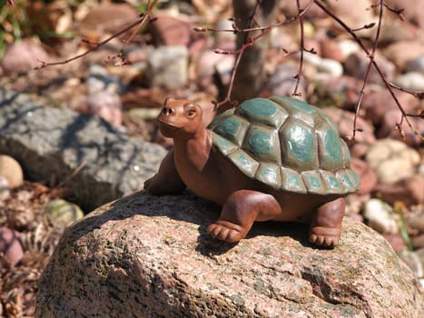 Cute stone turtle statue as a decoration item in a garden    