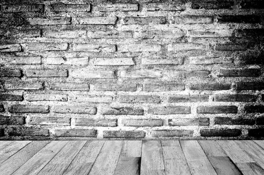 empty room with red brick wall and wooden floor