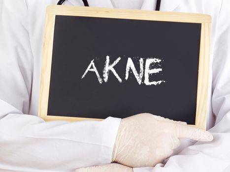 Doctor shows information on blackboard: acne in german