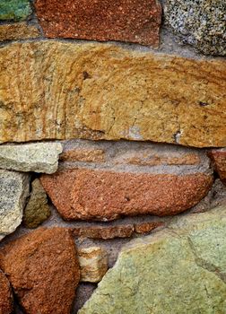 Background of Big Colored Cracked Brick Stones closeup