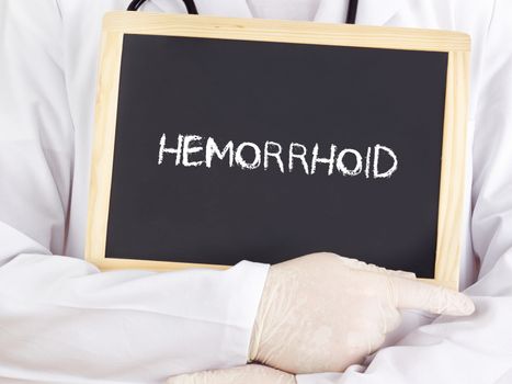 Doctor shows information on blackboard: hemorrhoid
