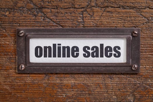 online sales  - file cabinet label, bronze holder against grunge and scratched wood