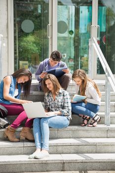 Students sitting on steps studying at the university