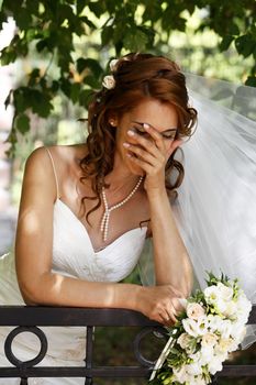 The beautiful bride on a green background