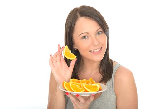Attractive Young Woman Holding a Plate of Sliced Fresh Juicy Oranges Segments