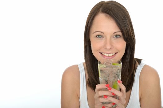 Healthy Young Woman Holding a Glass of Iced Water with Lime