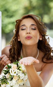 The beautiful bride on a green background