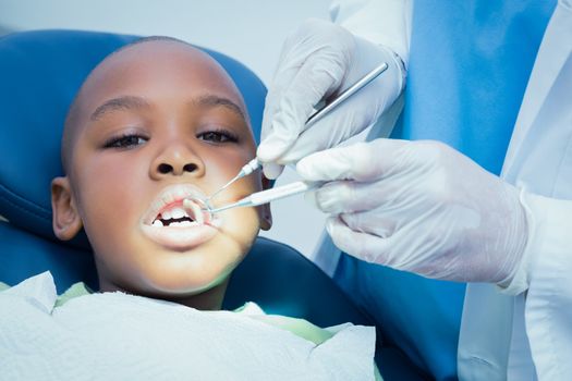 Close up of boy having his teeth examined by a dentist