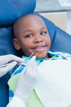 Close up of boy having his teeth examined by a dentist