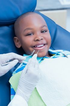 Close up of boy having his teeth examined by a dentist