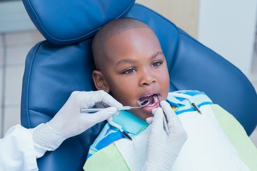 Close up of boy having his teeth examined by a dentist