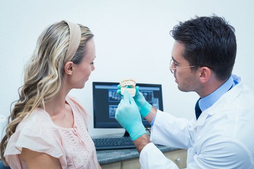 Side view of male dentist showing woman prosthesis teeth