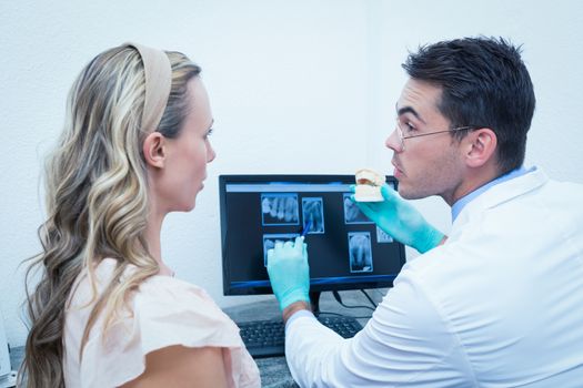 Side view of male dentist showing woman prosthesis teeth