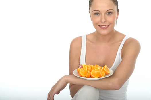 Attractive Happy Healthy Young Woman Holding a Plate of Fresh Cut Oranges