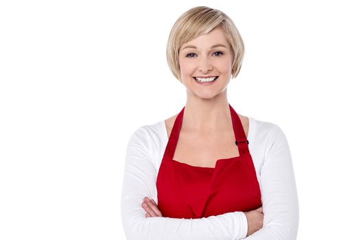 Happy female chef with folded arms