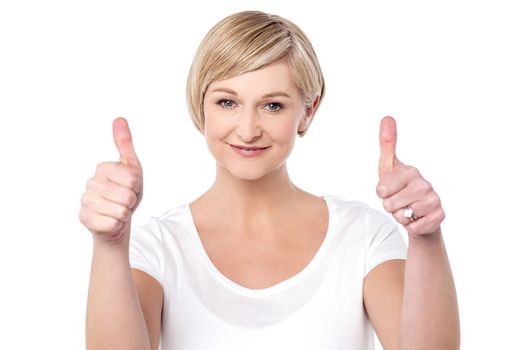 Successful woman making thumbs up gesture