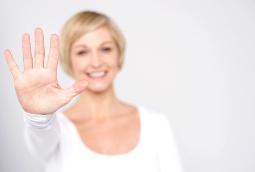 Smiling woman making high five with her hand