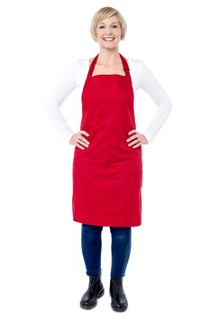 Full length of woman chef with hands on her waist