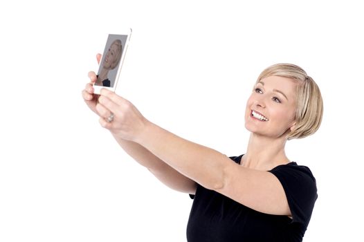 Smiling woman taking a picture of herself