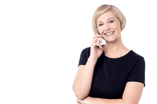 Smiling woman talking on her mobile phone