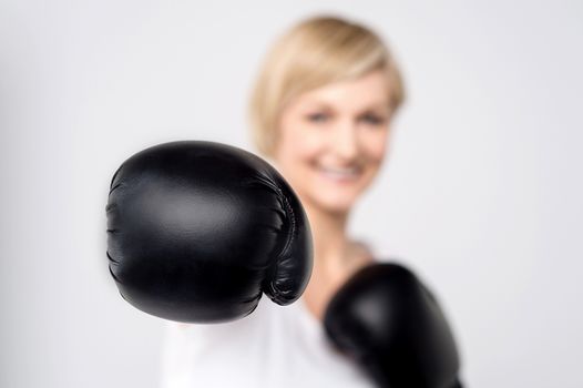 Woman with black boxing gloves, focus on gloves.