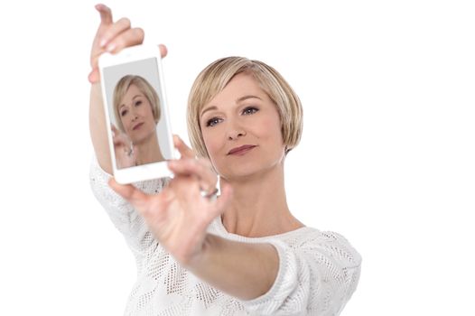 Beautiful woman taking selfie with smartphone