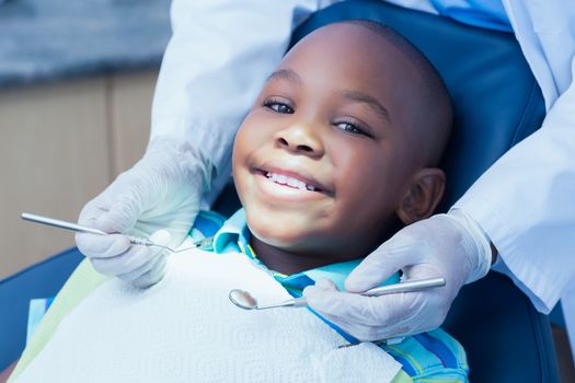 Close up of boy having his teeth examined by a dentist