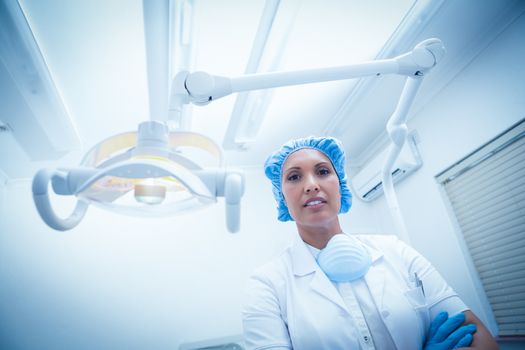 Low angle portrait of serious female dentist