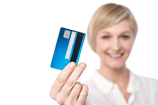 Woman showing credit card, focus on card.