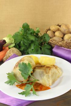 Cabbage roulade with potatoes and sauce on a napkin